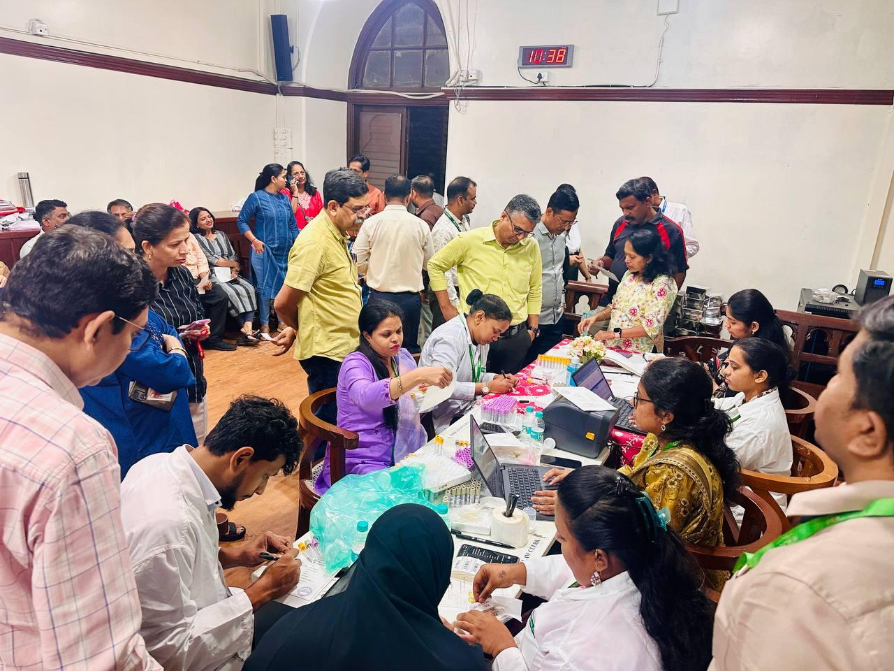 Crowded health camp with employees participating and queueing for tests