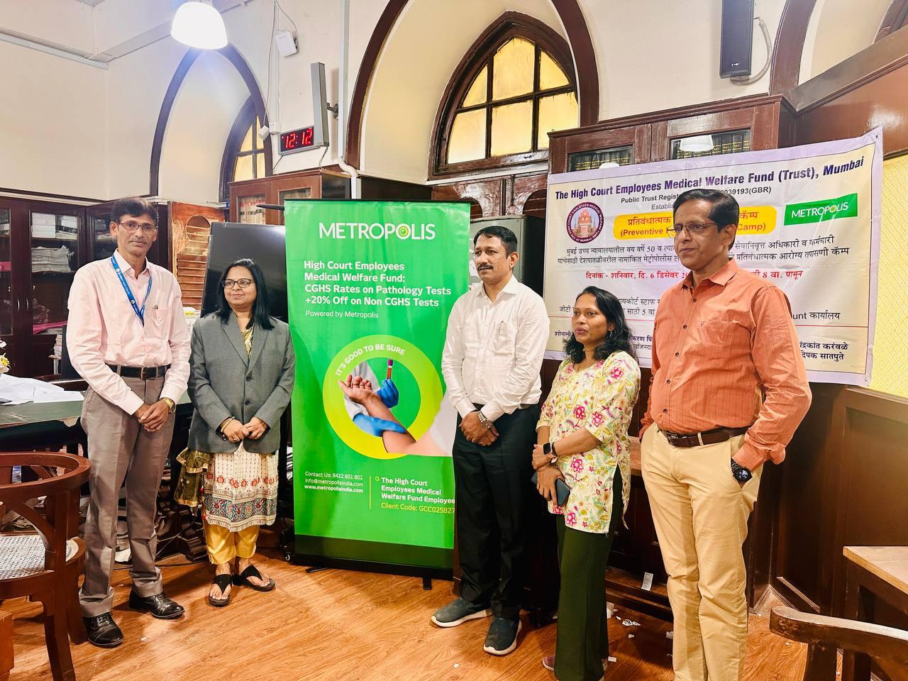 Trustees alongside Metropolis partnership banner